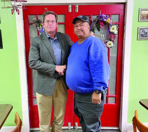 Pictured is Bradley McDonald of Acadiana Waste Services, LLC, (left) as he congratulates Hampton Frank (right) on his recent retirement. (Photo courtesy of Bradley McDonald)