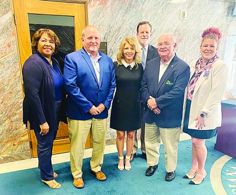 Among those pictured with State Senator Heather Cloud (center) are Woodworth mayor David Butler (left of center) and Addis mayor David Toups (right of center). (Photo courtesy of Senator Heather Cloud)
