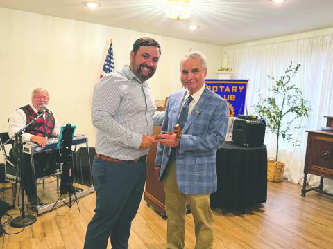 PASSING THE GAVEL - Outgoing president Beau Wilson (left) handed off the president’s meeting gavel to newly-installed president Dr. Kirk Soileau (right). (Gazette photos by Heather Bogard)