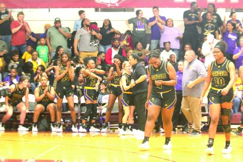 Ville Platte native and head coach of the Oakdale Lady Warriors Renotta Edwards (center right) celebrates with her team’s only senior Marlee Hart (center left) after defeating top seeded White Castle in the LHSAA Girls’ Basketball Quarterfinals. With the win, Edwards advanced to the former Top 28 for the first time in her playing/ coaching career. (LSN photo by Tony Marks)