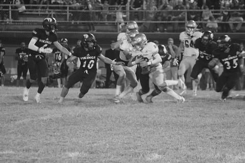 Trojan running back Jude Hebert (23) looks to turn a corner for additional yards in Sacred Heart’s 40-6 loss to Opelousas Catholic Thursday night. (Gazette photo by Rhett Manuel)
