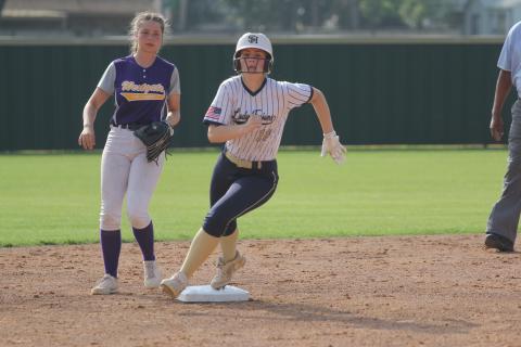 Catherine Larson (12) sets her eyes on Sacred Heart head softball coach Todd Ardoin, who coaches third base, as she rounds the second base bag in a 15-0 win over Westgate. (Gazette photo by Tony Marks)