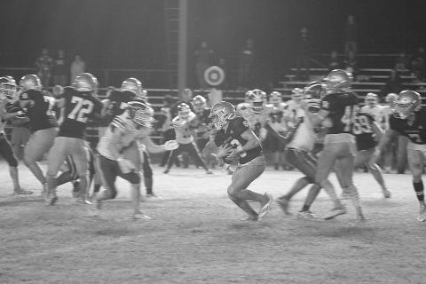 Jude Hebert (23) fights for additional yardage on a slick Soileau-Landry Field against the visiting Covenant Christian Lions in the first round of the Select Division IV playoffs. With the 32-8 win, Sacred Heart now travels to Ouachita Christian in the second round. (Gazette photo by Rhett Manuel)
