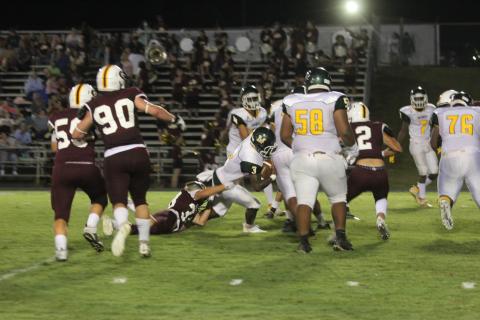 Mamou quarterback Jalon Bradley stays on his feet as he nets positive yardage on a drive that resulted in a touchdown in the Green Demons’ 36-30 road loss to Grant. (Gazette photo by Tony Marks)