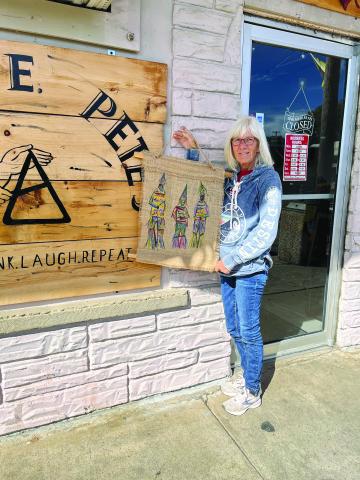 Kay Granger is shown with one of her many displays that hang inside the Greas E. Pete’s in Mamou. (Gazette photo by Heather Bogard)