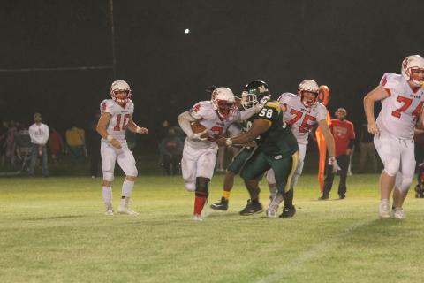 In a game against Port Barre earlier this season, Jaclarion Fontenot (58) attempts to make a tackle against Andre Tremble (3). The Green Demons now host Pine Prairie tomorrow night after earning a district opening win against Ville Platte last week. (Gazette photo by Tony Marks)
