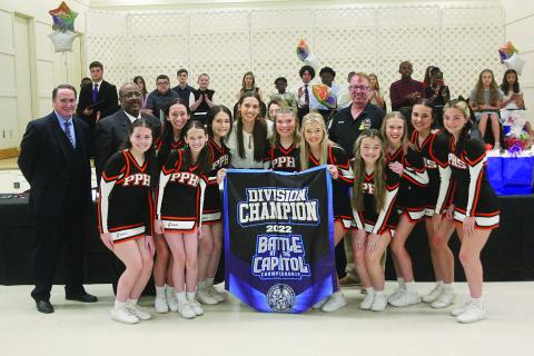 Pine Prairie High School cheerleaders (from left) Gracie Vidrine, Grace Holsomback, Carli Maricle, Addison Watts, Samara Lafleur, Alaina Boutte, Alexis Bordelon, Olivia Kidder, Skyla Fontenot, and Ava Kordish present a banner to captain Ainsley Dutton (center) at the Student of the Year Gala held Tuesday, May 3. Dutton, earlier that night, was recognized as the school district’s 12th grade student of the year. 