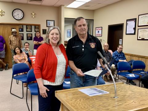 Community Liaison Jerri Ledoux (left) presents Ville Platte Firefighter Robert Perron (right) with a Congressional Commendation from U.S. Congressman Mike Johnson, who represents the state’s 4th district. Perron was honored for 50 years of service to the Ville Platte Fire Department. (Gazette photo by Nancy Duplechain)