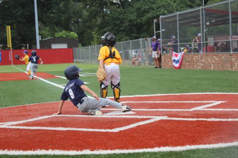 Ville Platte 7U Coach Pitch All-Star Jacques Fontenot slides into home plate to score a run in a 12-1 win over Benton in four innings last Thursday. The 7U All-Stars had a successful weekend, going 5-2 and finishing in third place in the state tournament to qualify for the World Series in Monroe. (Gazette photo by Rhett Manuel)