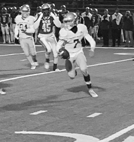 Hayden Droddy (7) scrambles as a play tries to develop for Sacred Heart in the Trojans’ playoff loss to Ouachita Christian Friday night. (Gazette photo by Rhett Manuel)