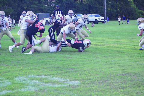 The Sacred Heart defense converges to make a stop against Pine Prairie in the Evangeline Parish Jamboree. The Trojans begin the season 1-0 after earning a win over Ville Platte High because of a forfeit. (Gazette photo by Rhett Manuel)