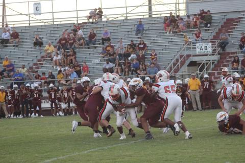 Elijah George (2) muscles his way forward for some of his 364 rushing yards against Elton. He ran 32 times and scored five touchdowns on the night. (Gazette photo by Rhett Manuel)
