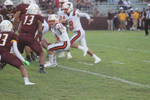 Chase Holsomback (14) looks to block an Elton defender in order to provide running room for quarterback Branson Fontenot. The Panther now head to Buckeye for a Week 3 matchup. (Gazette photo by Rhett Manuel)