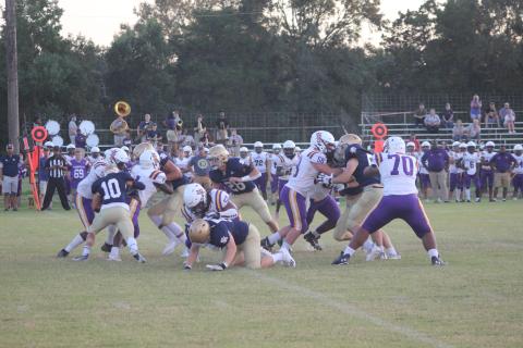The stout Sacred Heart defensive unit combines to make a stop in the Trojans’ 35-7 win over Marksville last week. The Trojans now host parish rival Basile at Soileau-Landry Field in a Week 3 matchup. (Gazette photo by Rhett Manuel)