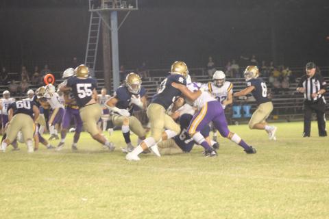 Sacred Heart’s dual threat option Caleb Hood (3) gains positive yards for his Trojans who collected a home win against Class 3-A Marksville. (Gazette photo by Rhett Manuel)