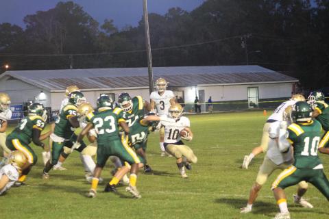 Blake Hebert (10) looks to find a seam against the Mamou defense earlier this season. Hebert and the rest of his Sacred Heart Trojans look to grab a win against their arch-rival Blue Jays in Eunice tomorrow night. (Gazette photo by Rhett Manuel)