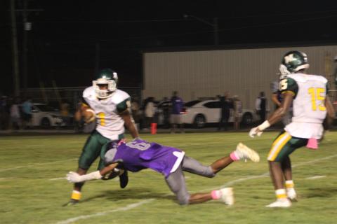 Jakhalan Slaughter (6) of the Ville Platte High Bulldogs lays out for a tackle on Mamou’s Jerez Edwards (7) in the district opening contest for both teams. (Gazette photo by Rhett Manuel)