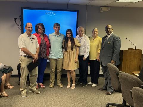Pictured from left are Pine Prairie Assistant Principal Ted Fontenot, Secondary Supervisor Liz Chatelain, Grant Welch, Sophee Latour, school board members Wayne Dardeau and Monica Andrus, and Superintendent Darwan Lazard. 