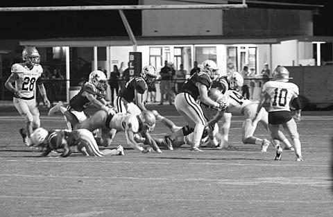 Ellis Shipp (14) makes a tackle against a St. Ed’s Blue Jay in the Sacred Heart Trojans’ 40-7 win on the road in Eunice. The Trojans now host Opelousas Catholic Friday for the district title. (Gazette photo by Rhett Manuel)
