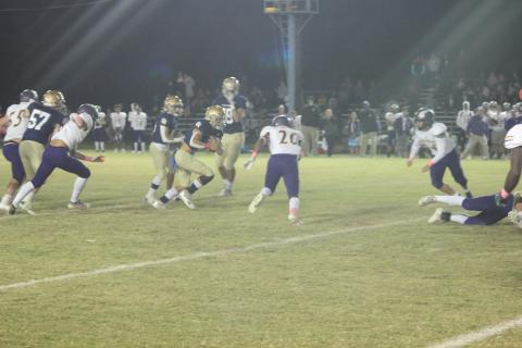 Sacred Heart starting quarterback Caleb Hood (3) tries to find a running lane in the Trojans’ 14-6 home loss to Opelousas Catholic. (Gazette photo by Rhett Manuel)