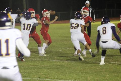 Basile quarterback Luc Johnson (4) drops back and tries to find an open receiver in the Bearcats’ regular season ending 20-13 over Oberlin Thursday night. (Gazette photo by Rhett Manuel)