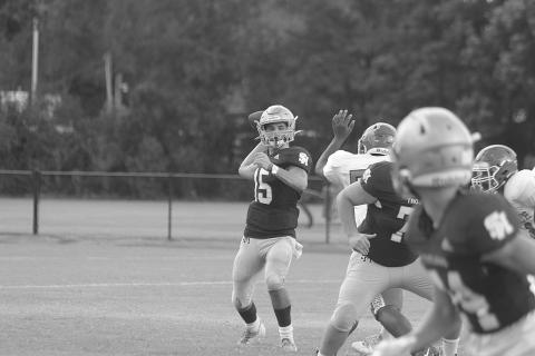 Wade Pitre (15) delivers a pass for Sacred Heart against Bunkie in a pre-season scrimmage. In Week 3, against Basile, he delivered pass to Hayden Droddy for 21 yards and a touchdown as time expired to put his Trojans at 3-0 on the season. (Gazette photo by Tony Marks)