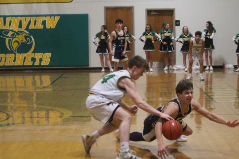 Austin Darbonne (21) goes after a loose basketball as his Sacred Heart Trojans take on the Hustlin Hornets of Plainview. Darbonne scored 11 of his 19 points in the fourth quarter as his team earned a 76-44 win. (LSN photo by Tony Marks)