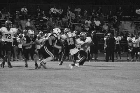Caydon Descant (78) and Seth Ramsey (58) give chase and look to force a stop against Northwest in Pine Prairie’s 54-7 home loss Thursday night. (Gazette photo by Tony Marks)