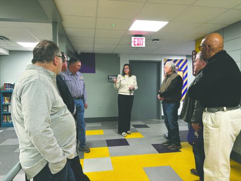 ERA Principal Alice LeJeune (center) leads members of the VIlle Platte Rotary Club on a tour of the Evangeline Reimagine Academy campus.