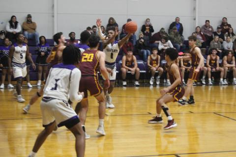 Davontae Fontenot (0) tries to maintain possession of the basketball in Ville Platte’s home game against Iota last Friday night. (Gazette photo by Rhett Manuel)