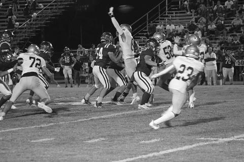 A Sacred Heart defender leaps up to deflect a pass in the Trojans win against St. Edmund last week. (Gazette photo by Rhett Manuel)