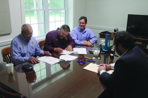 Evangeline Parish Police Jury President Bryan Vidrine (second from left) signs the cooperative endeavor agreement among the Evangeline Parish Law Enforcement District, Evangeline Parish Sheriff, and police jury for the construction of a new 200-bed jail in the Industrial Park at an estimated cost of $18 million. Also pictured are Sheriff Charles Guillory (left), Police Jury Secretary-Treasurer Donald Bergeron (center) and Parish Attorney Jacob Fusilier (right).
