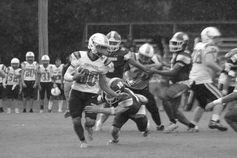 Pine Prairie’s Draylin Freeman (30) looks to elude a tackle from Mamou’s Payton Ashford (15) in the opening game of the Evangeline Parish Jamboree in Basile. (Gazette photo by Sylis Manuel)