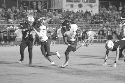 Ville Platte’s Kailep Hall (11) stays on his feet as he gains nine yards down to the Pine Prairie 5-yard line in a Bulldog 28-0 win over the Panthers in the final game of the Evangeline Parish Jamboree last Friday night in Pine Prairie. (Gazette photo by Tony Marks)