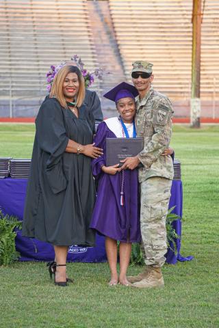 Ville Platte High School graduate Jazlyn Ardoin (center) received a special surprise while receiving her diploma. Her father, Army Staff Sergeant Brannavon Ardoin (right) was approved for military leave to attend his daughter’s graduation. They are shown with Principal Shelsy Williams. (Photo courtesy of Trayvon Wilson)