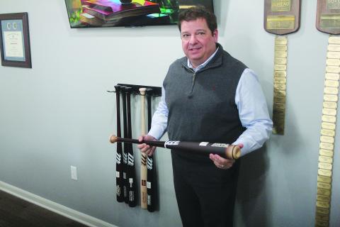 Jeremy Ortego, new agency manager of Evangeline Parish Farm Bureau, shows off a Marucci baseball bat, which was a Grand Slam award for performing at the top 10%. (Gazette photo by Tony Marks)