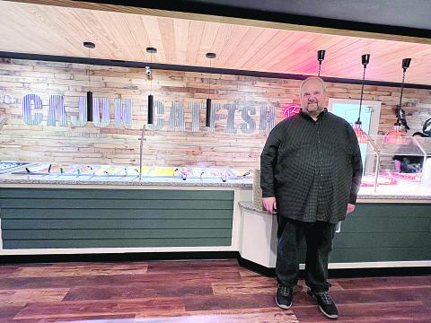 John Deville is pictured as he stands in a newly renovated Cajun Catfish Buffet, which recently celebrated its 10th anniversary. (Gazette photo by Nancy Duplechain)