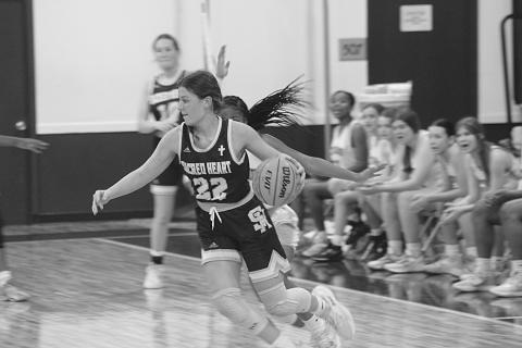 Sacred Heart’s Kali Shiver (22) moves toward the net in the Lady Trojans’ season ending loss to Delta Charter Monday night. Shiver was the leading scorer with 13 points. (Gazette photo by Rhett Manuel)