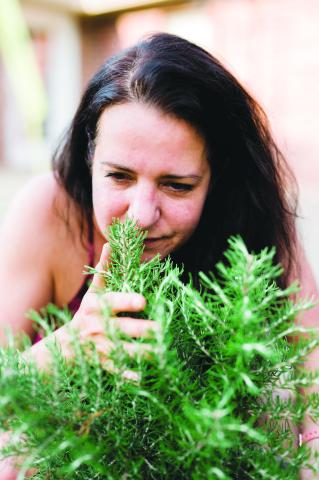 Kayla Kincanon, a master herbalist, checks out one of many herbs used in natural healing. (Photo courtesy of Kayla Kincanon)
