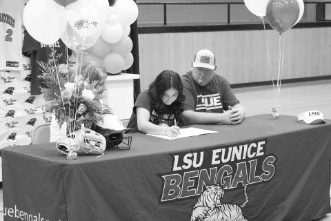Ava Kordish (center) signs the paperwork to officially join the LSUE softball team during a ceremony held inside the Pine Prairie gym on Tuesday, November 14. Also pictured are her mother, Shelly Kordish; and her father, Skylar Kordish. (Gazette photo by Tony Marks)