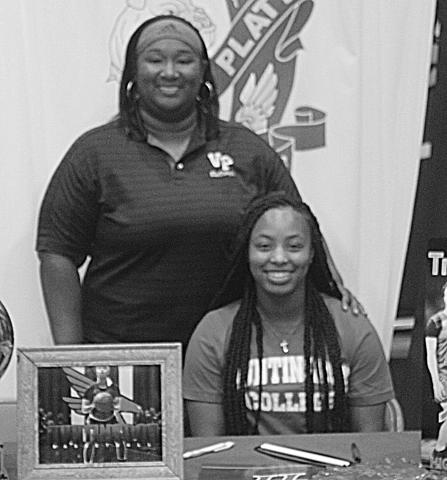 The former Ville Platte Lady Bulldog star Trinity Leday (seated) is pictured with her coach Rhonda Thomas (standing). (Gazette photo by Rhett Manuel)