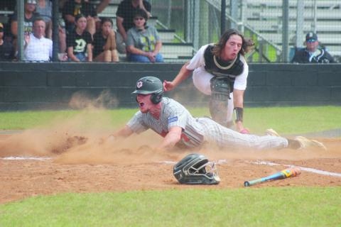 This photo of Caden Askey (7) sliding underneath a tag to score Pine Prairie’s second run in the top of the first inning in Game 3 against Berwick won 1st place for Best Sports Photo.