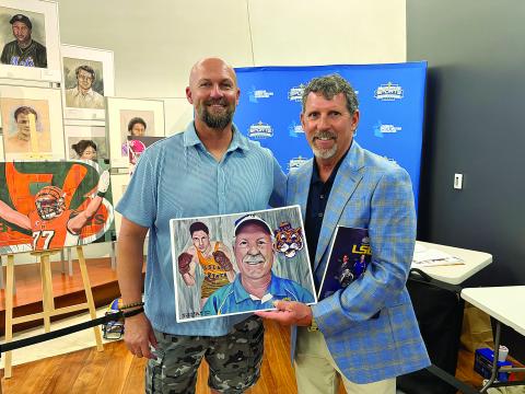 Artist Christopher Brown (left) presents artwork to Robert Soileau (right). The artwork commemorates Robert’s father George “Bobby” Soileau’s induction into the Louisiana Sports Hall of Fame.