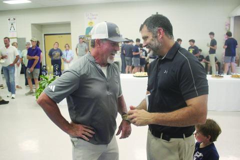 Robert Soileau (left), the son of Bobby Soileau, meets with Derek Landry (right), the grandson of RP “Cow” Landry and new head football coach and athletic director at Sacred Heart. (Gazette photo by Tony Marks)