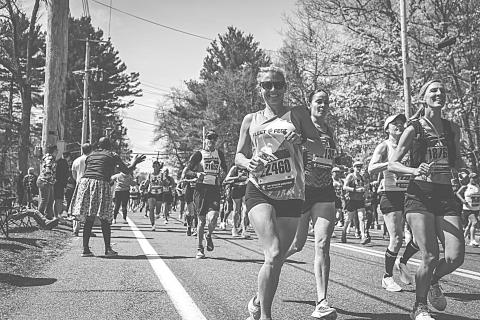Basile High School alumnus Leighe’ McClelland Roark  (center front) smiles as she comes downhill along with other runners in the Boston Marathon. 