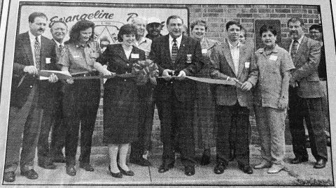 NEW 911 CENTER ONLINE - 911 Director Liz Hill and Sheriff Wayne Morein (front center cutting the ribbon) were among those celebrating the Evangeline Parish 911 system going online with a ribbon cutting and tour of the facility. Also among those pictured are District Attorney Brent Coreil and Clerk of Court Walter Lee. (Gazette archive photo)