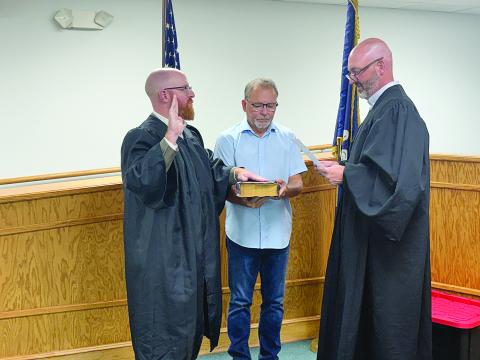 Christopher Ludeau (left) takes the oath of office after being appointed as magistrate of the Village of Pine Prairie. Administering the oath during the village council meeting held Thursday, September 10, is Ville Platte City Court Judge and Village of Pine Prairie Attorney Gregory Vidrine (right). Holding the Bible is Pine Prairie Mayor Quint West (center).
