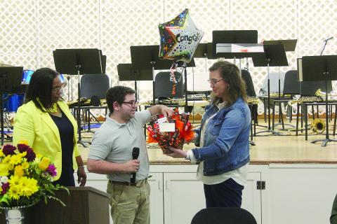 Pine Prairie Principal Alice Lejeune (right) presents a gift basket to Nicholas Stelly (center) in recognition of him being named Outstanding Work Based Student of the Year. Also pictured is Transition Specialist Dot Doulet (left). (Gazette photo by Tony Marks)