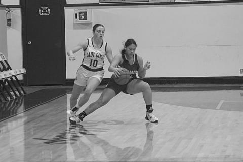 Maddie Fontenot (right) dribbles past an Iota defender in the Mamou Lady Green Demons’ 60-30 loss Thursday night. (Gazette photo by Rhett Manuel)
