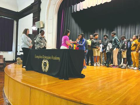 ERA seventh grader Majesty Soileau (right) receives her Evangeline Chamber of Commerce membership card from Chamber member Kristi Enicke as fellow members Trina Orgeron (left) and Linda Fontenot look on. (Gazette photo by Heather Bogard)